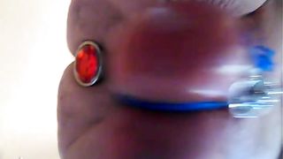 twin testicles and red plug in the ass