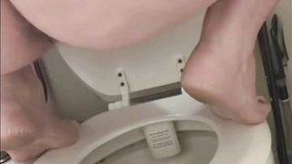 Girl with fat ass takes a shit while squatting on her toilet